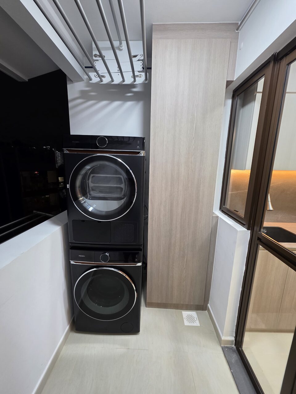 Service yard with woodgrain utility cabinet and stacked washer-dryer