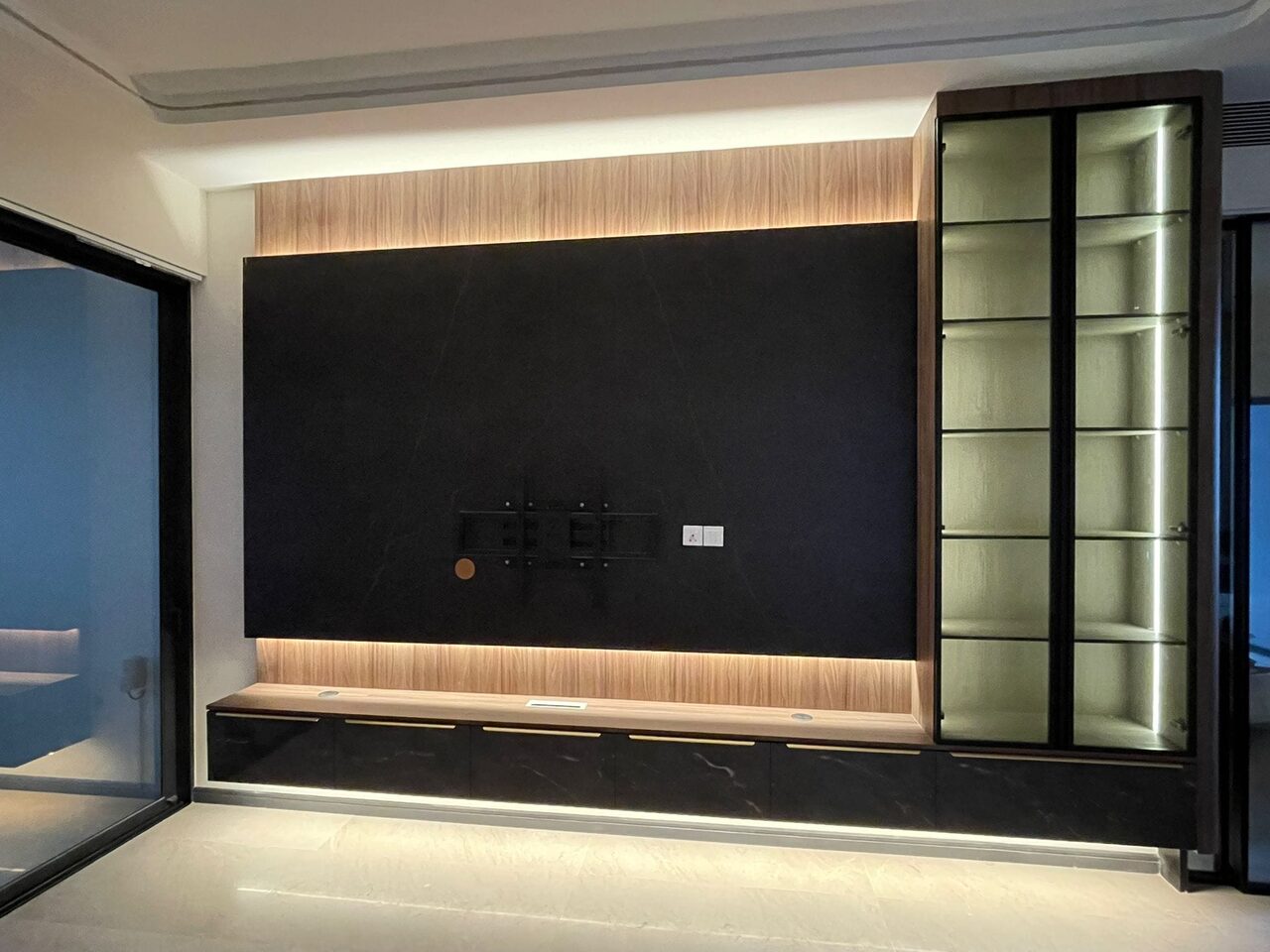 Evening view — lit cove and glowing brass display cabinet
