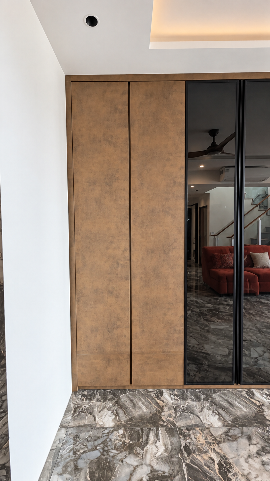 Full-height bookshelf revealed from flush cabinet panel