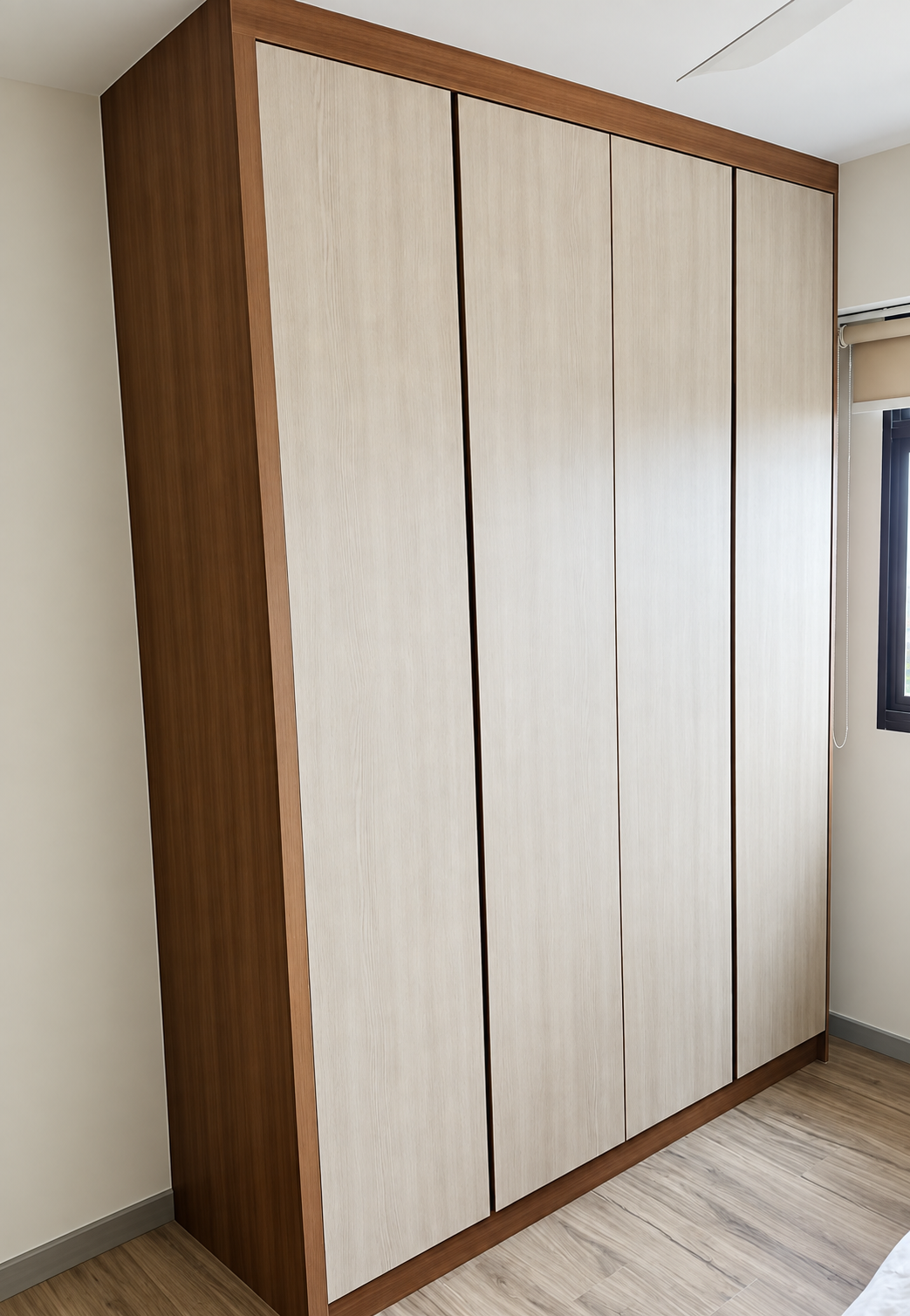 Wardrobe detail showing oak grain strip and matte black handle