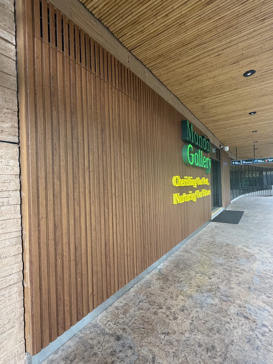 Colonnade walk beneath the slatted timber ceiling
