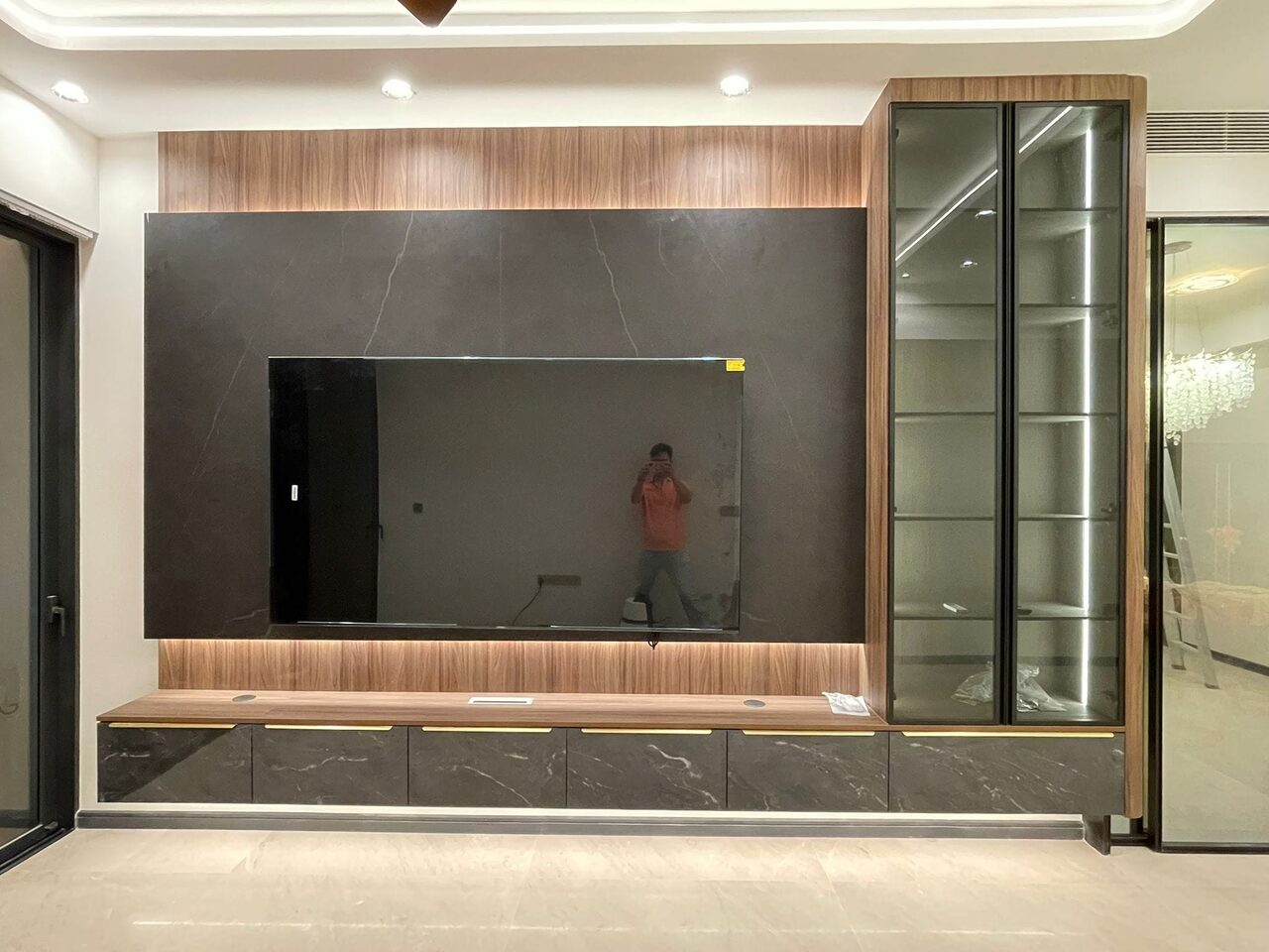 Completed charcoal-stone and walnut TV feature wall by day