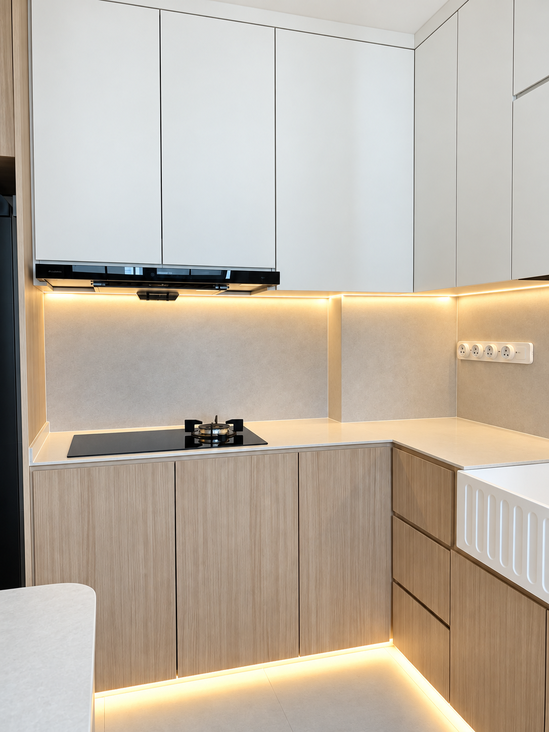 Kitchen L-shape full view — white uppers, oak lowers, induction hob, LED strips