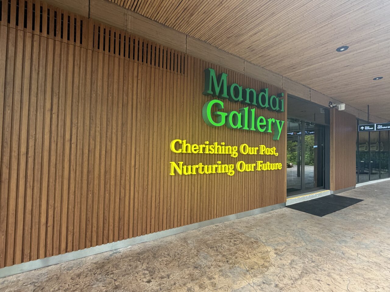 Mandai Gallery timber-batten facade with green-and-yellow signage