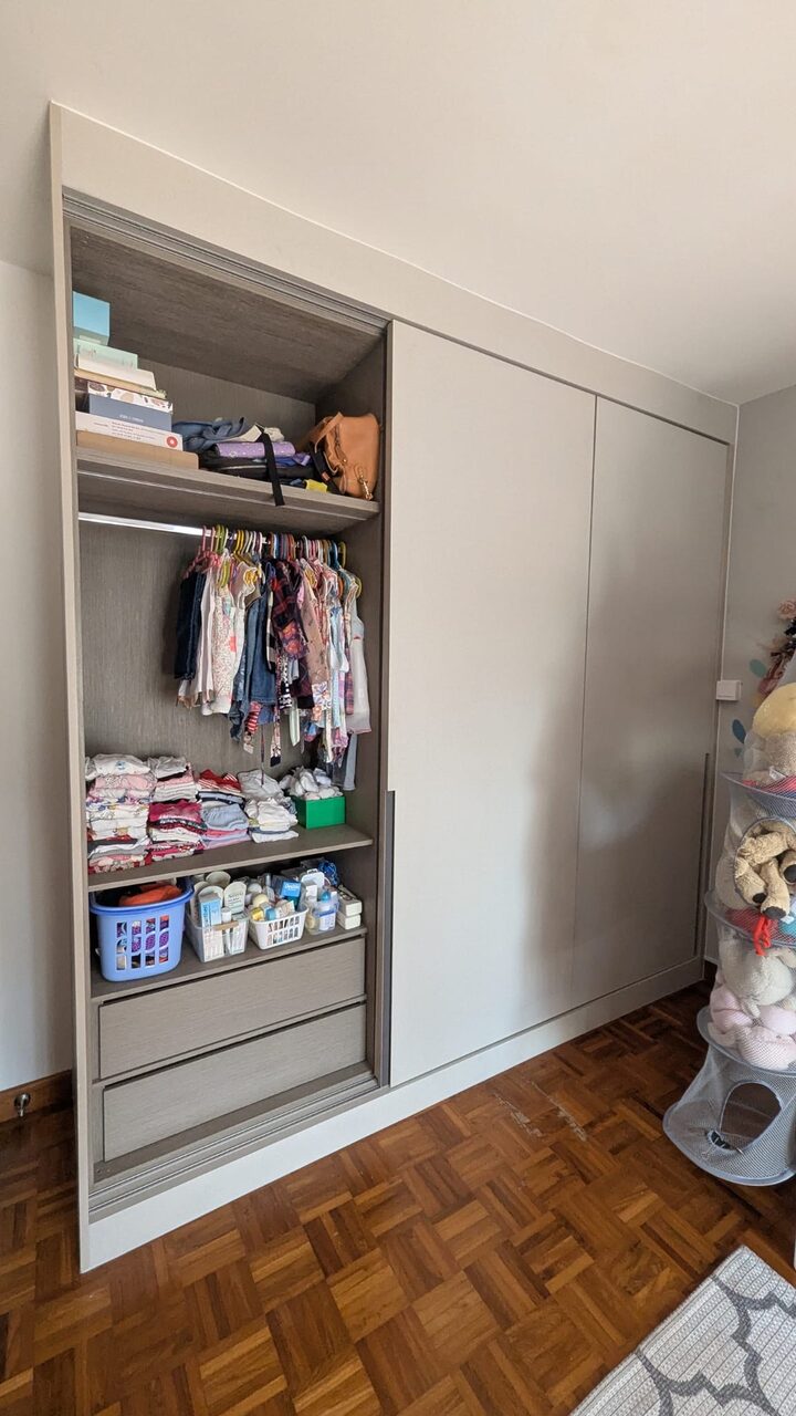 Open wardrobe interior with hanging rail, adjustable shelves and drawers