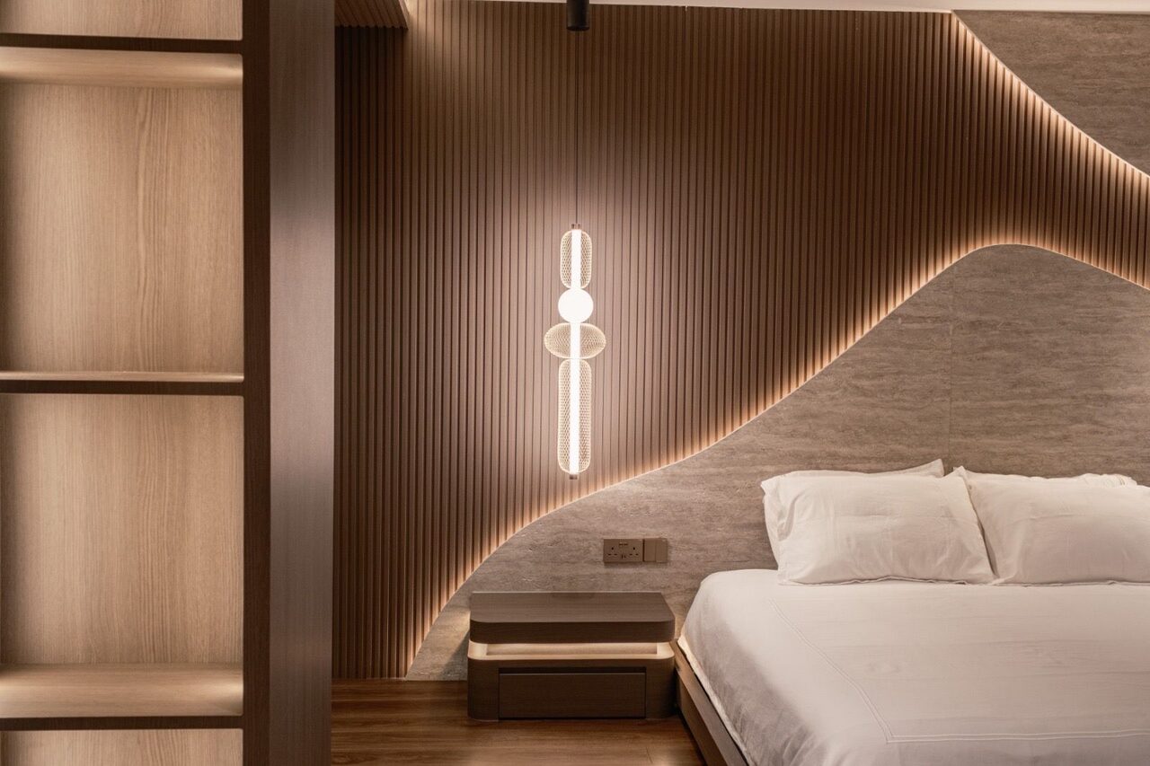 Floating nightstand and pendant detail against walnut fluting