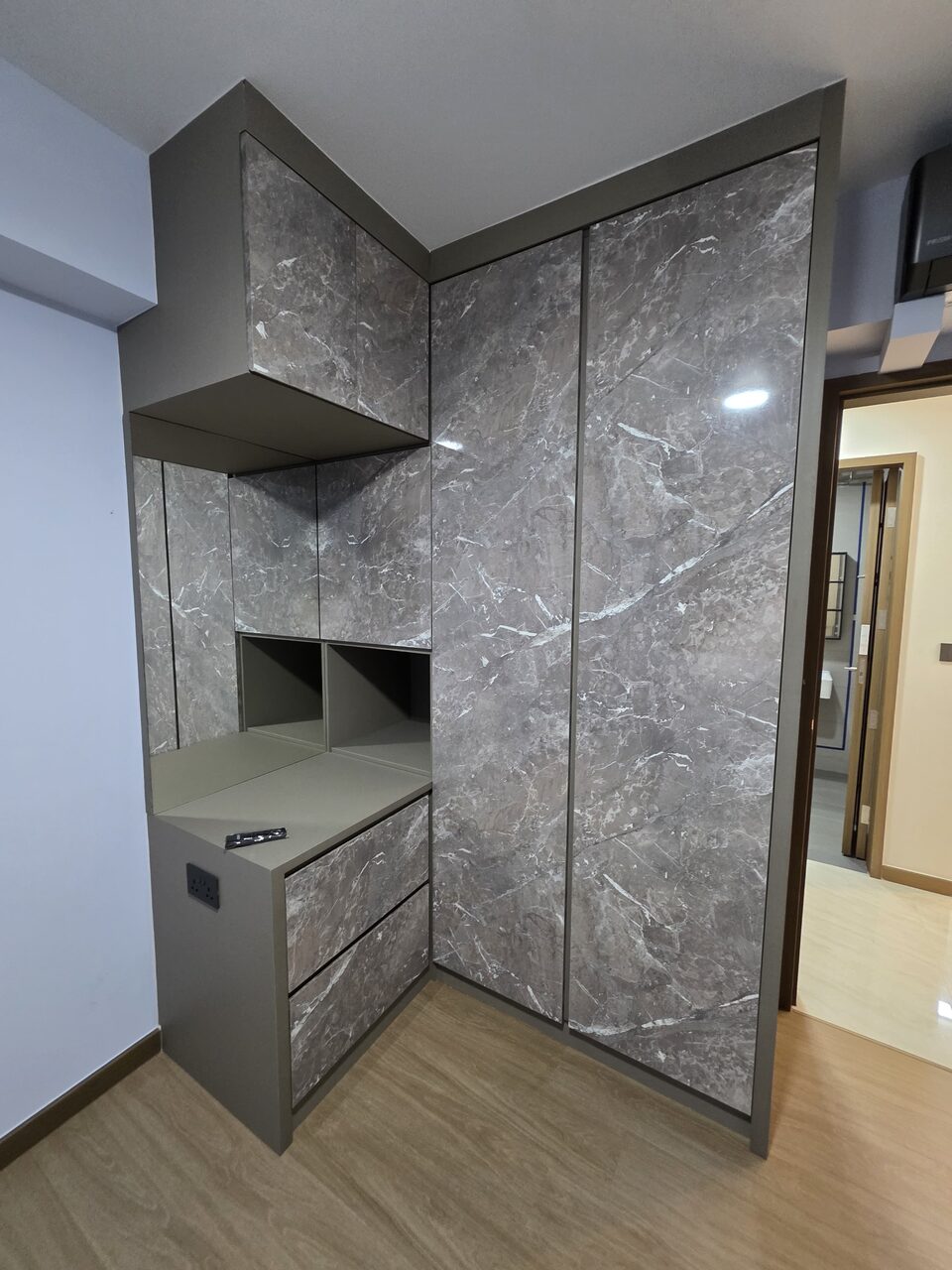 Grey-marble corner wardrobe with open display niche