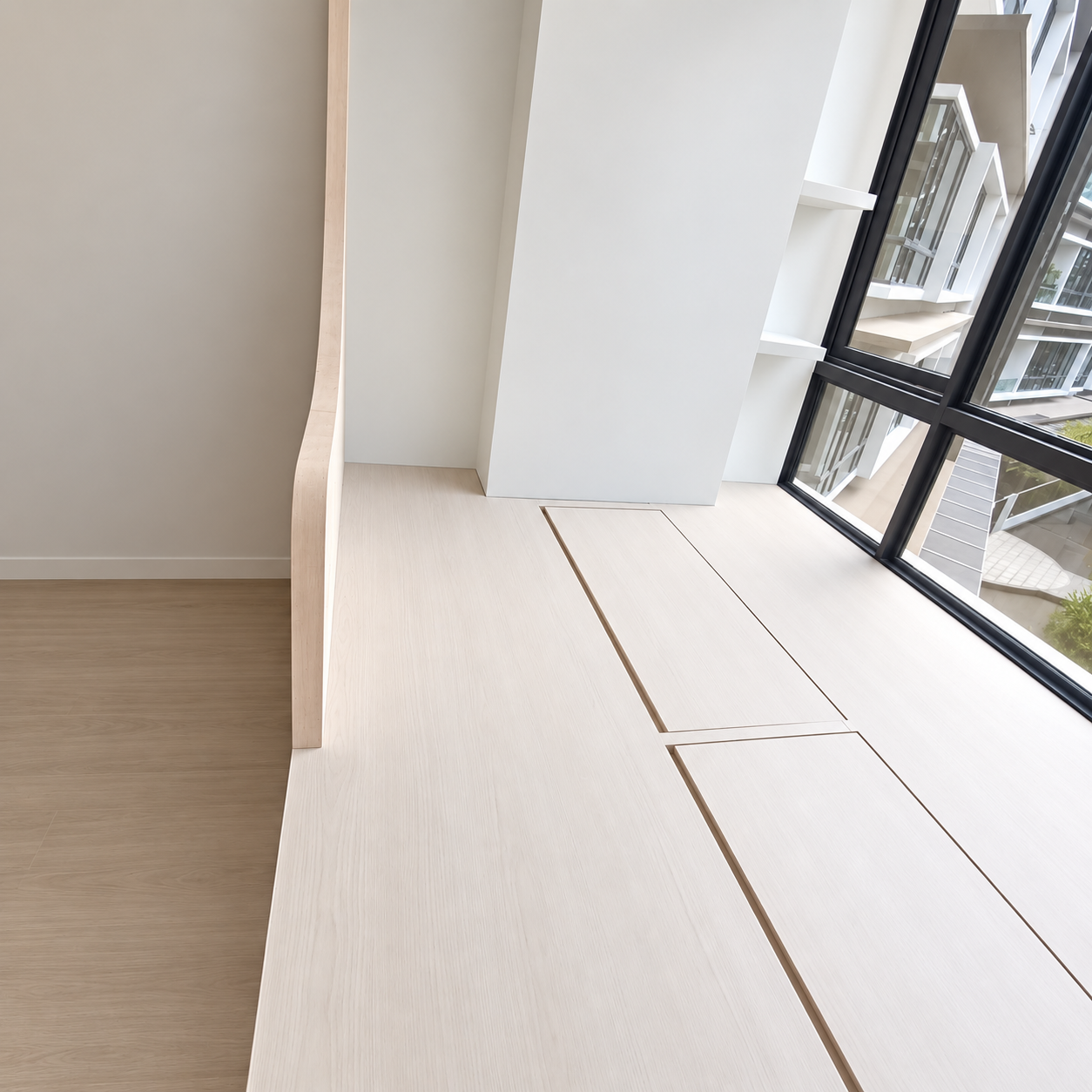 Platform bed detail — blush pink face panels with clean white base and oak ledge
