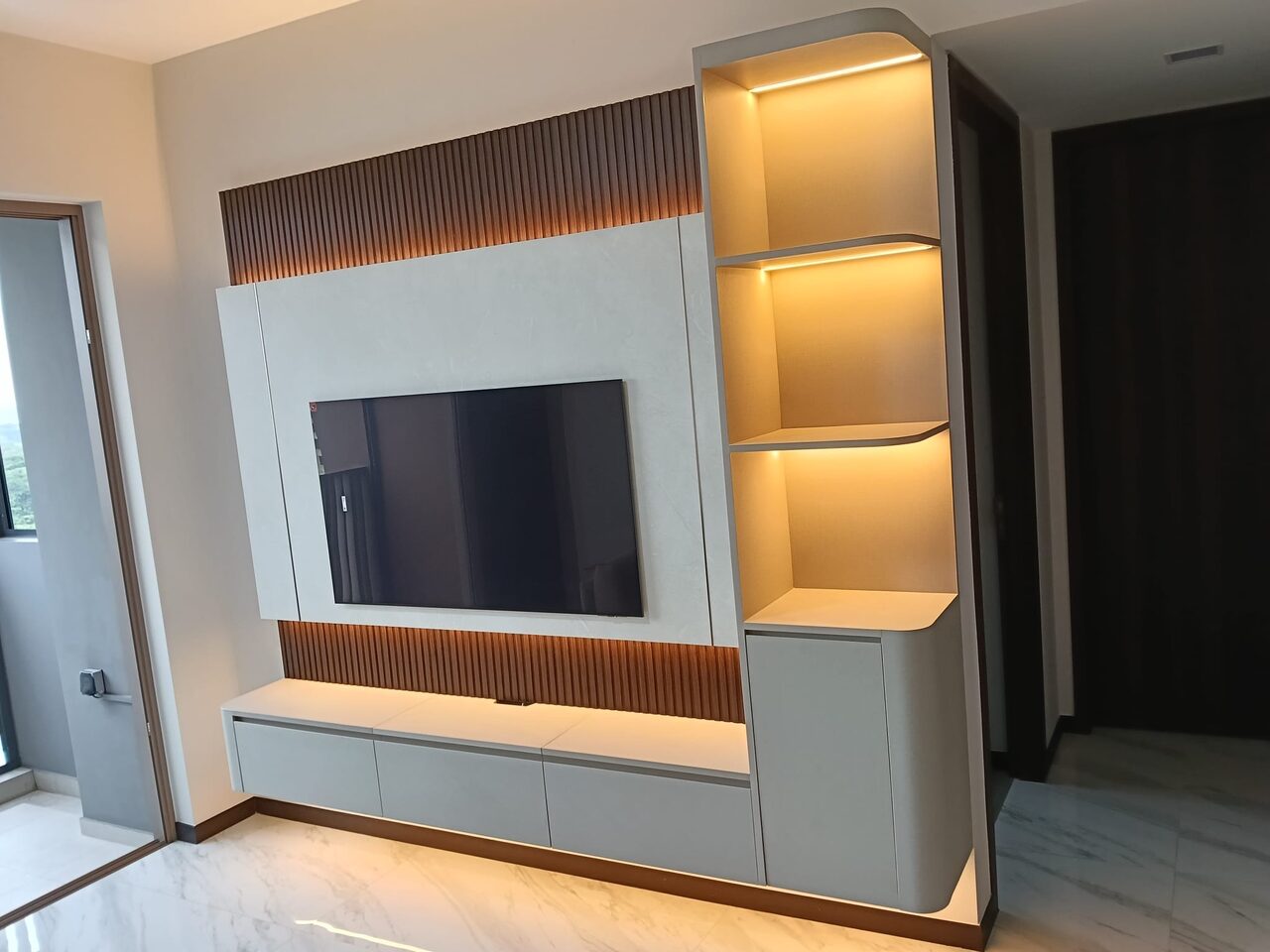 Lit stone and fluted-oak TV feature wall in Pasir Ris
