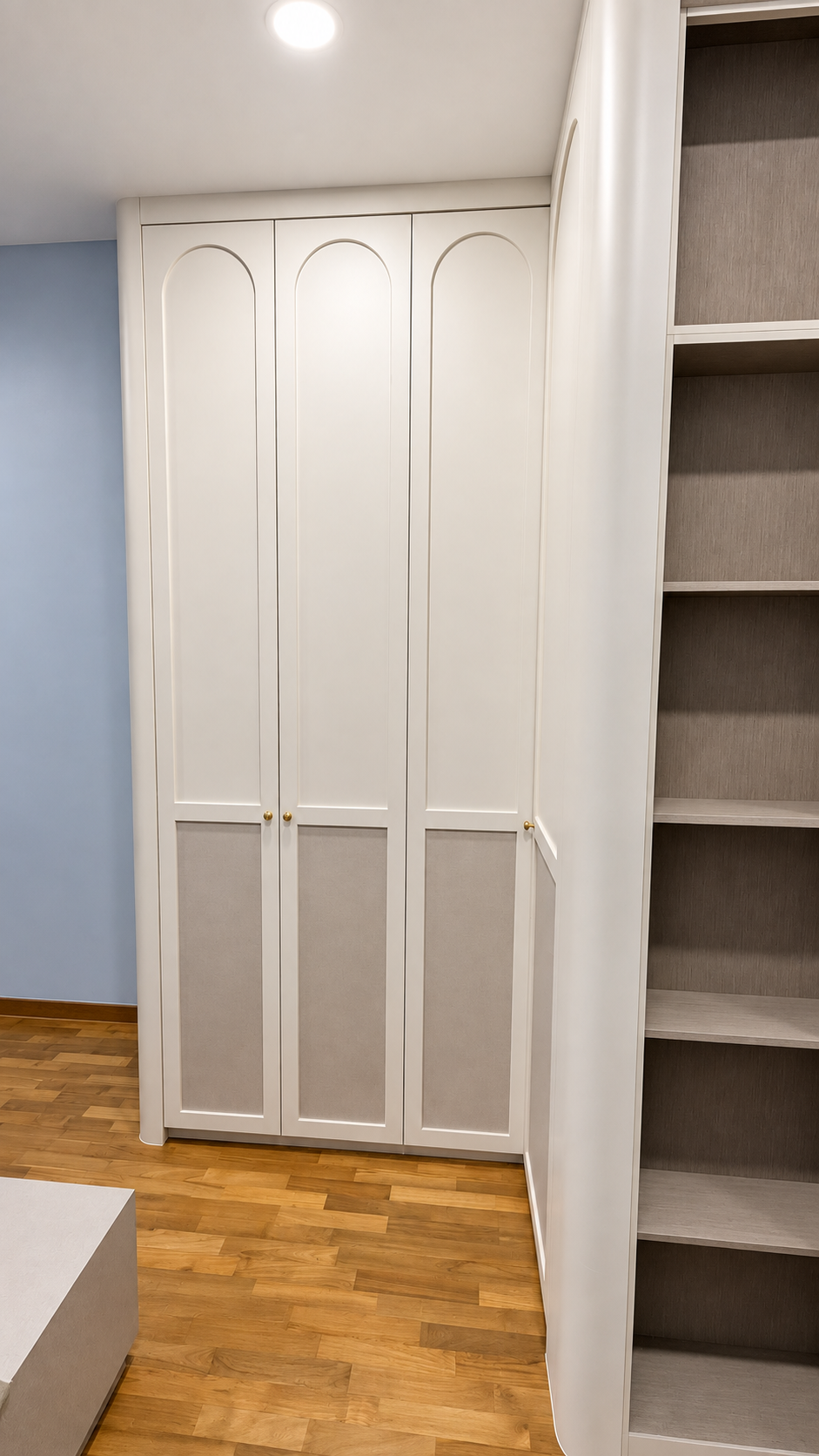Close view of arch-top wardrobe profile and handle detail