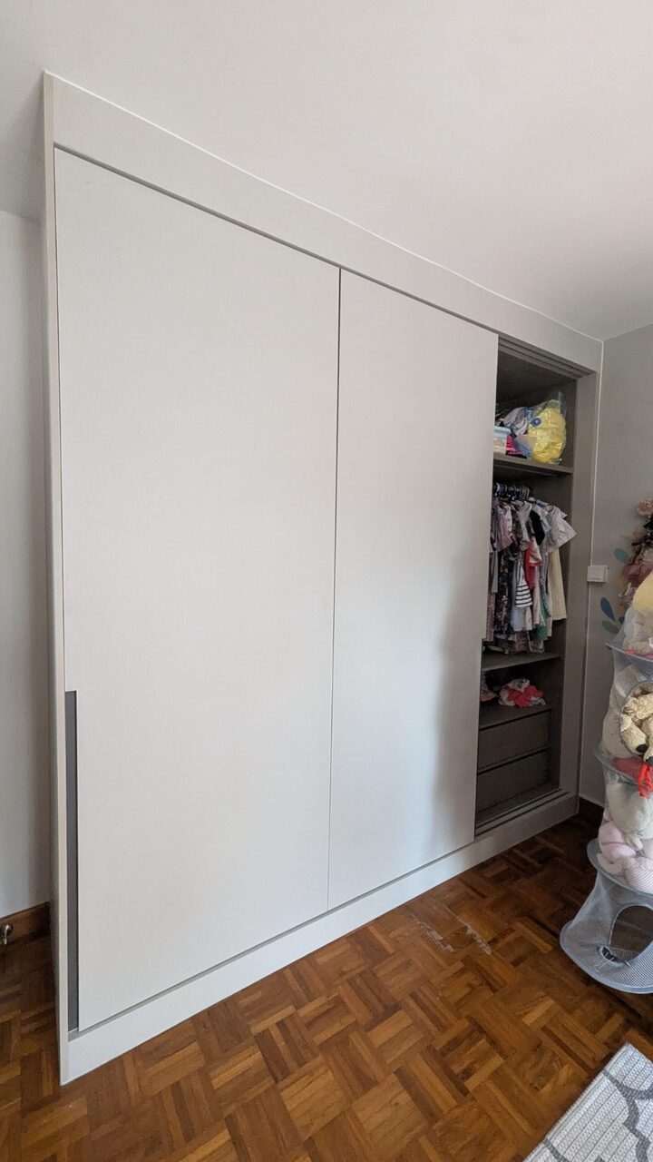 Cream sliding doors on recessed pulls, part-open