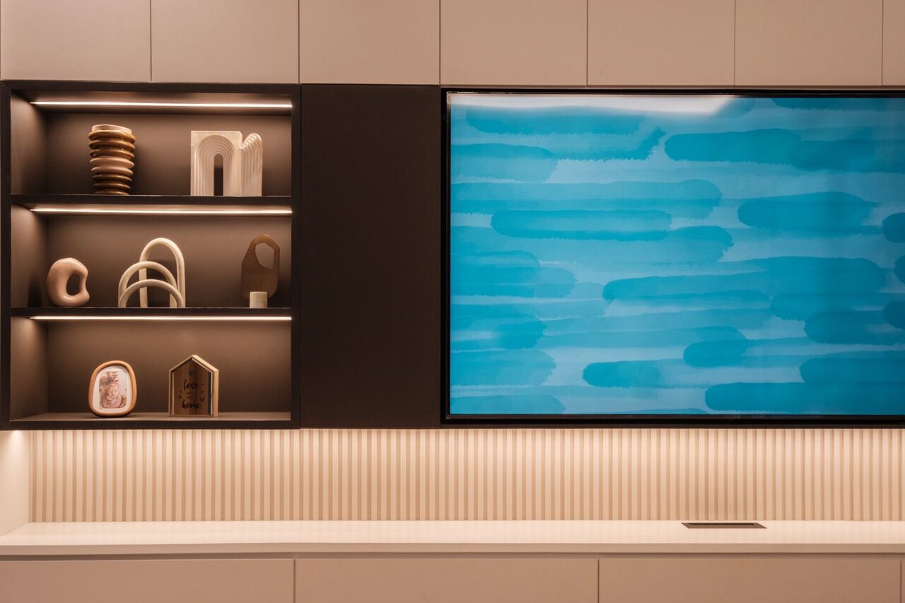 Lit display niche detail beside the floating TV