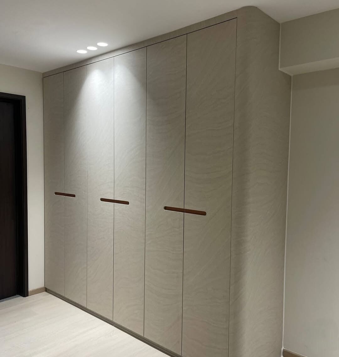 Pasir Ris HDB sandstone-wave wardrobe run with copper inlay handles