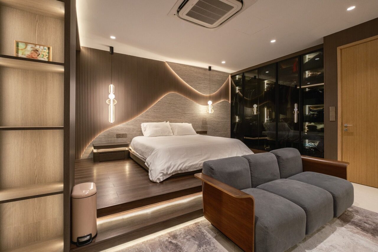 Primary suite with travertine wave headboard, platform bed and sitting area