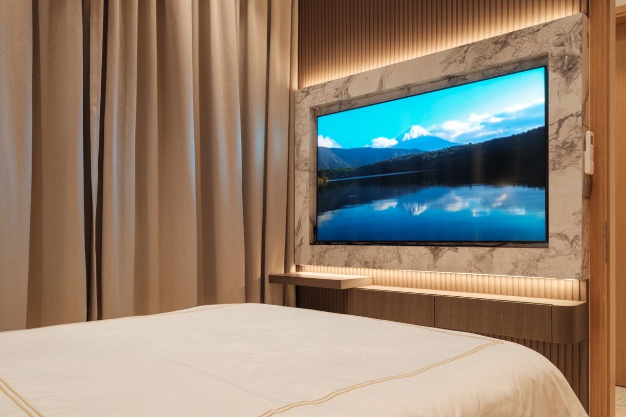 Marble-surround bedroom TV wall with floating console