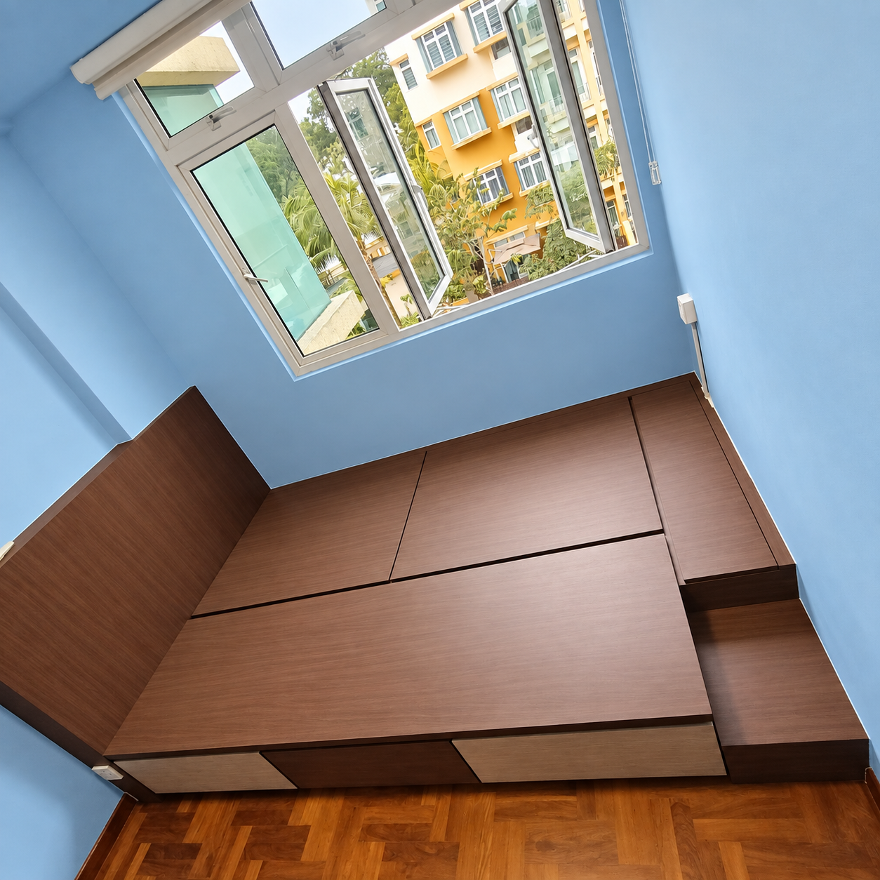 Overhead view of the closed walnut platform top panels and step storage unit