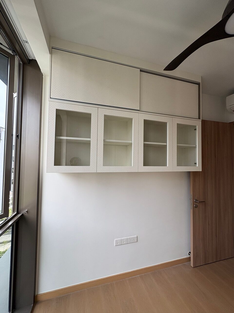 Glass-front display cabinets over the door