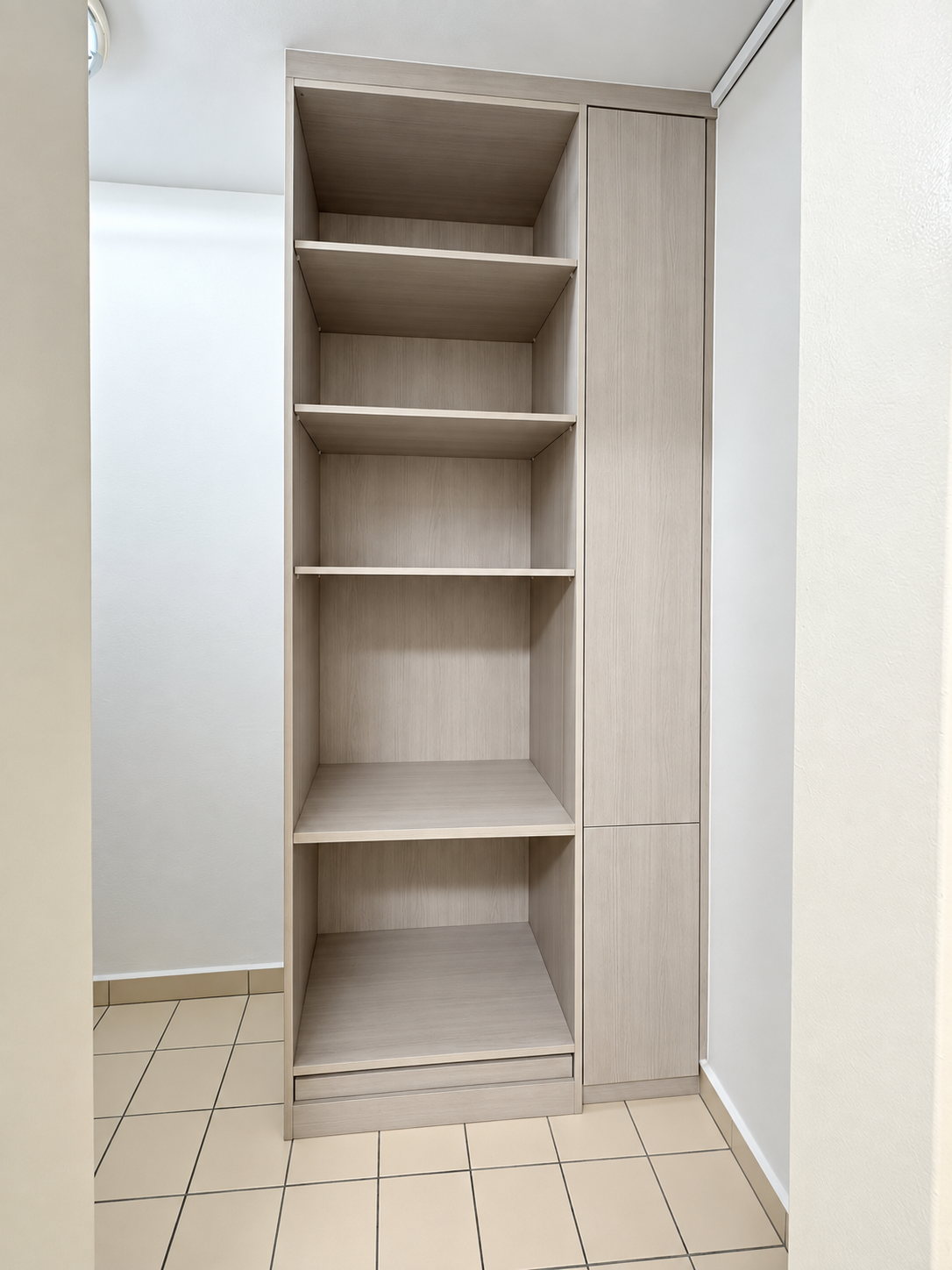 Open storage shelving unit in grey-taupe laminate with adjustable shelves and flush sliding panel