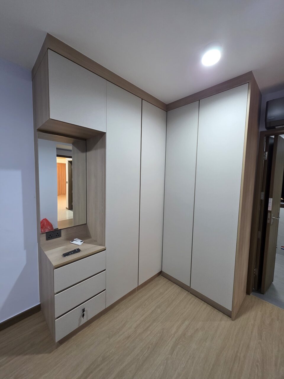 Soft-white bedroom wardrobe and dresser with framed mirror