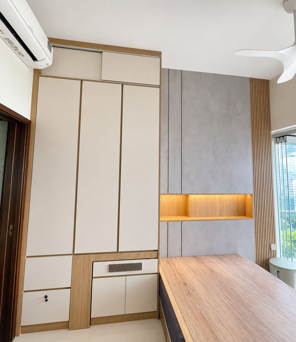 Master bedroom — cream wardrobe with oak reveal, concrete feature panel, LED niche