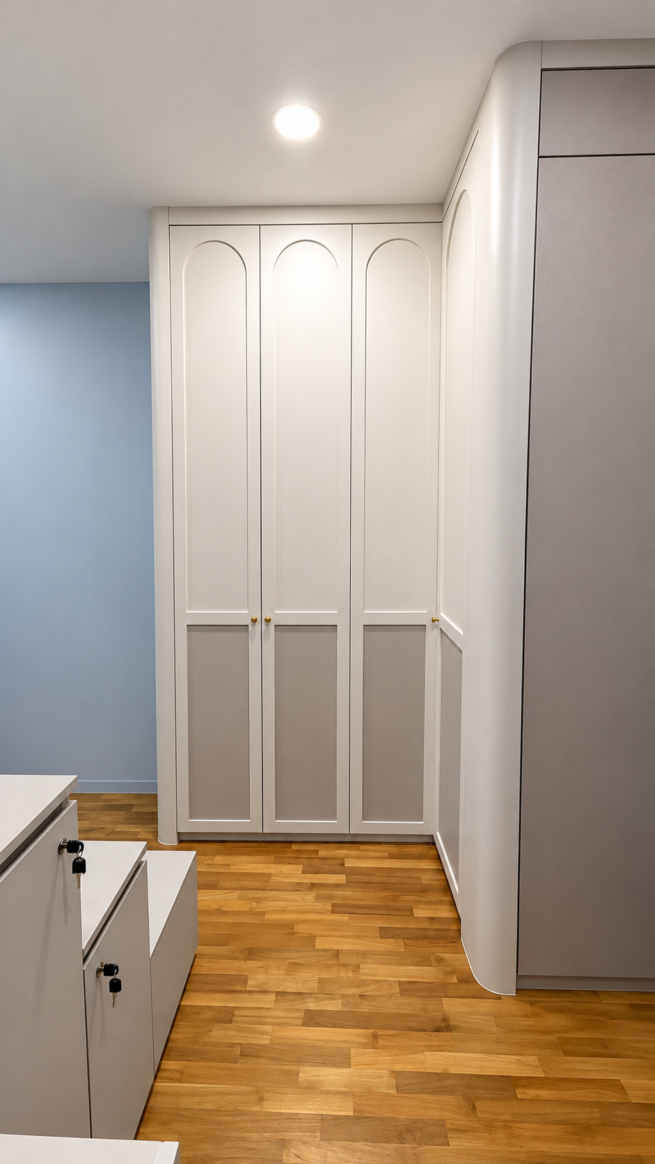 Arch-top white three-door wardrobe in kids room
