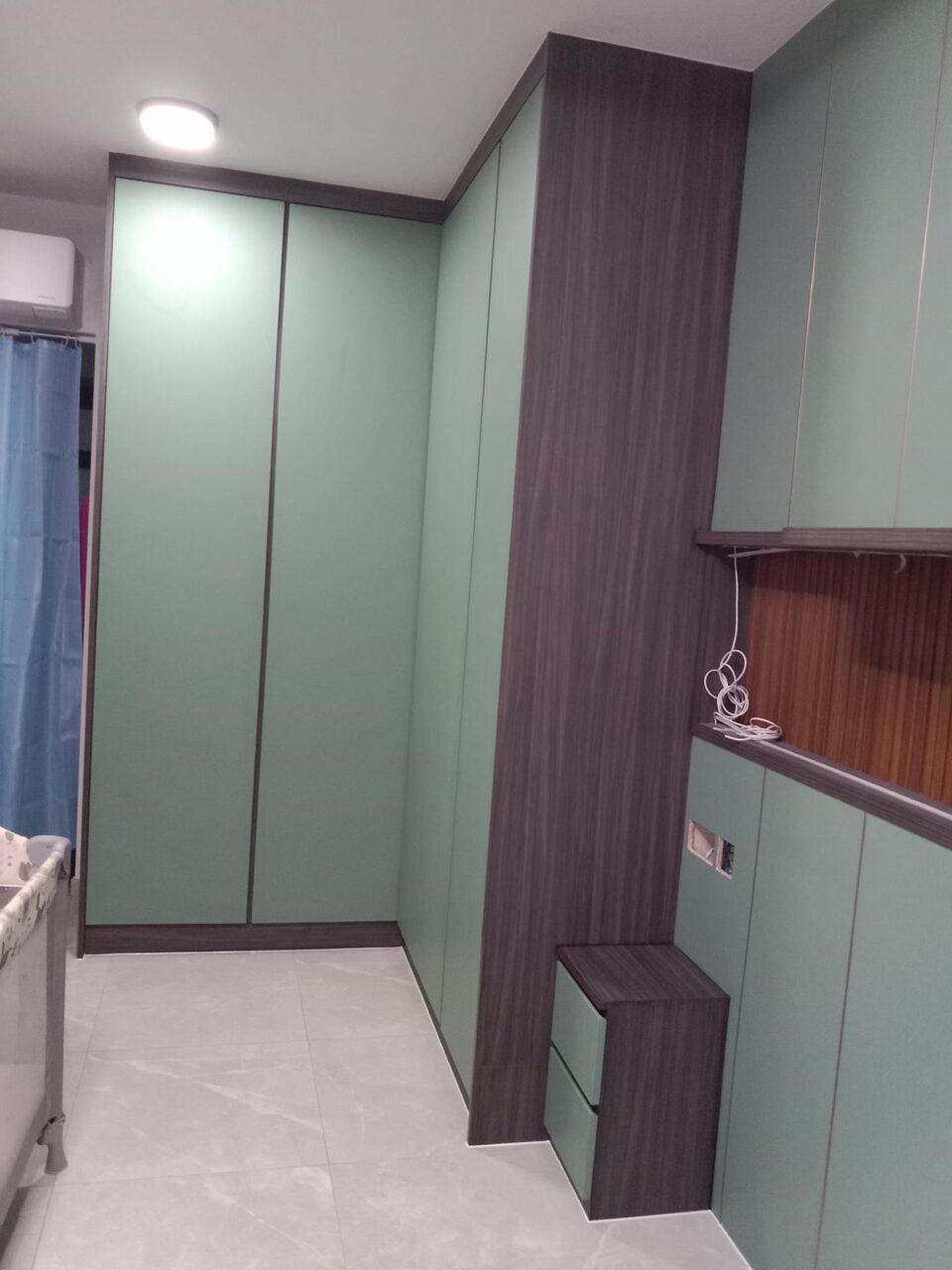 Sage wardrobe room with dark oak column