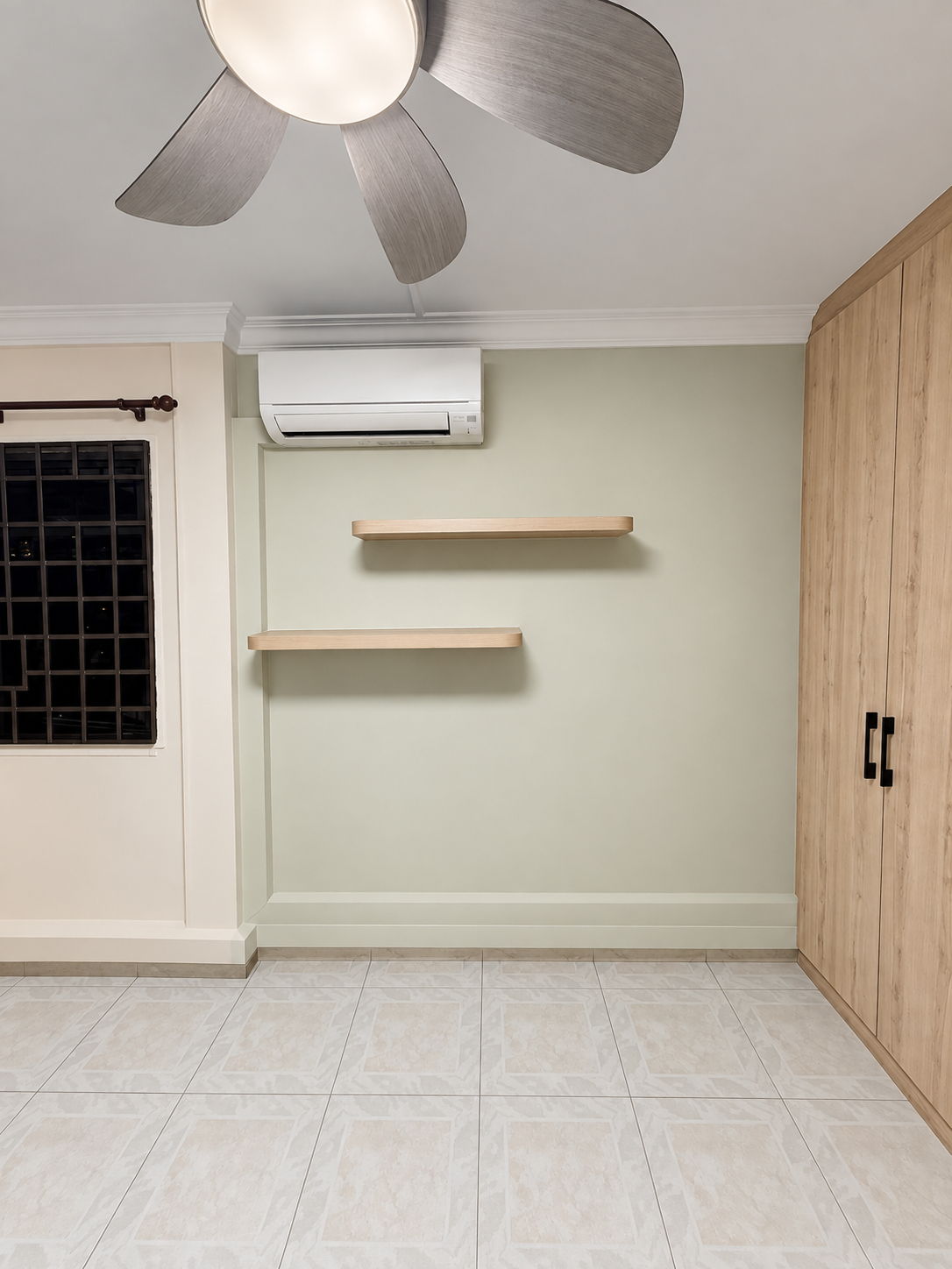 Sage green bedroom feature wall with floating oak shelves and corner oak wardrobe