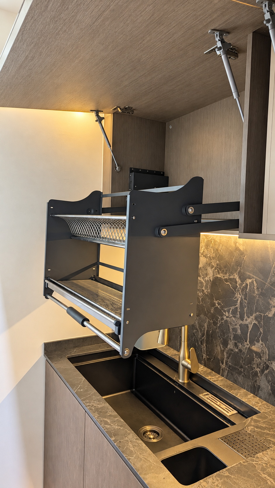 Dark kitchen brass tap and marble worktop detail
