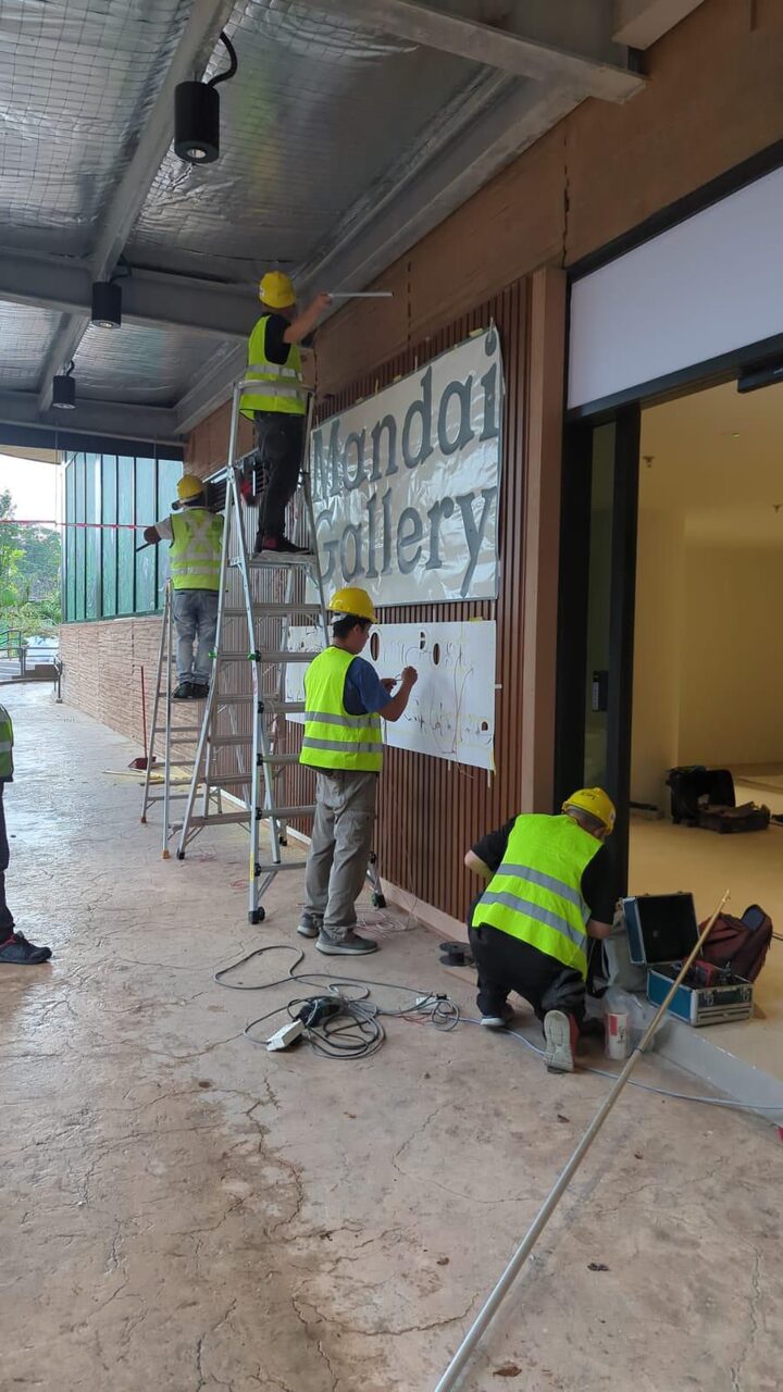 HOBI crew installing the Mandai Gallery facade and signage on site