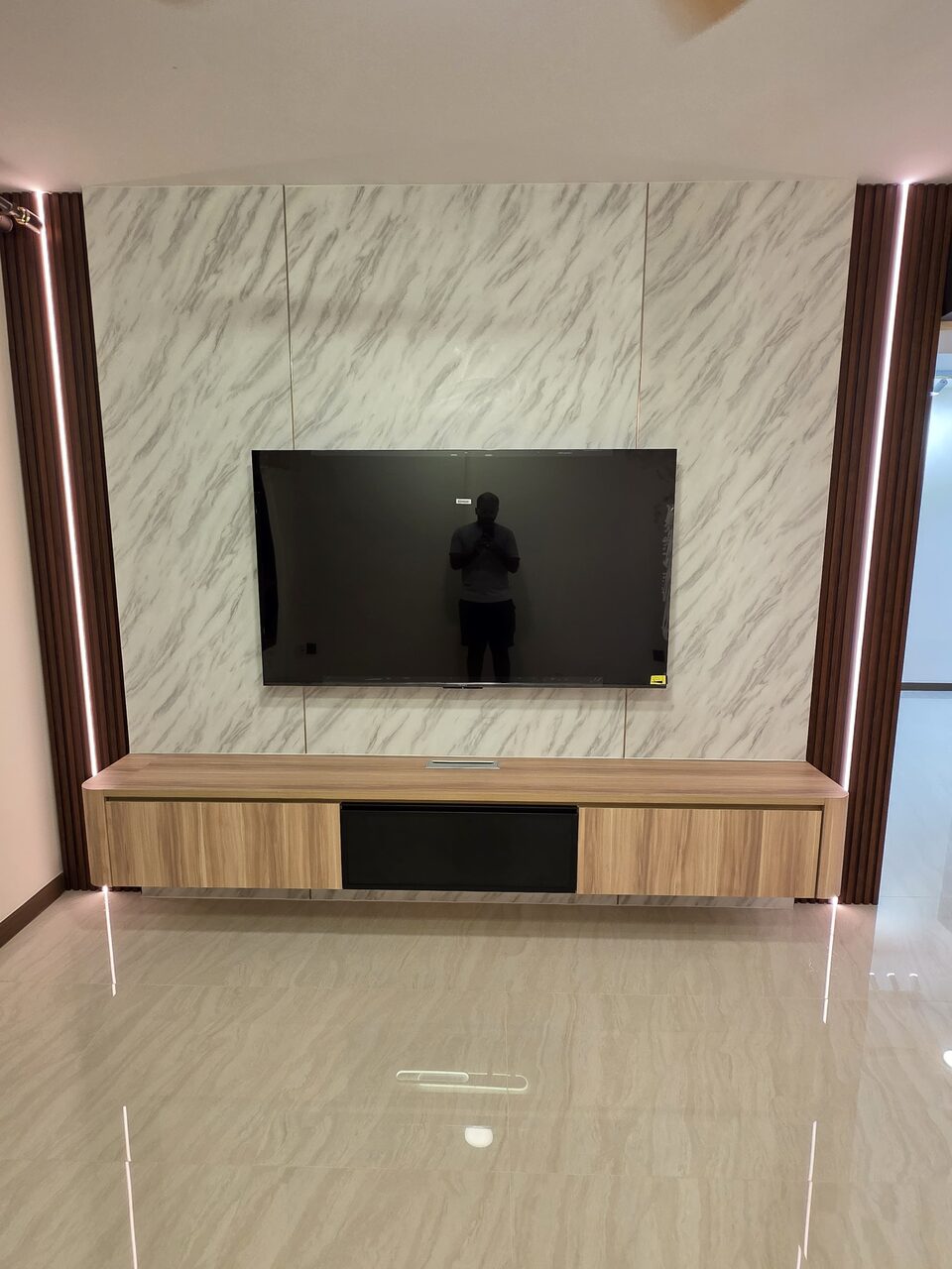 Sintered-marble TV feature wall with fluted-oak LED reveals and floating console