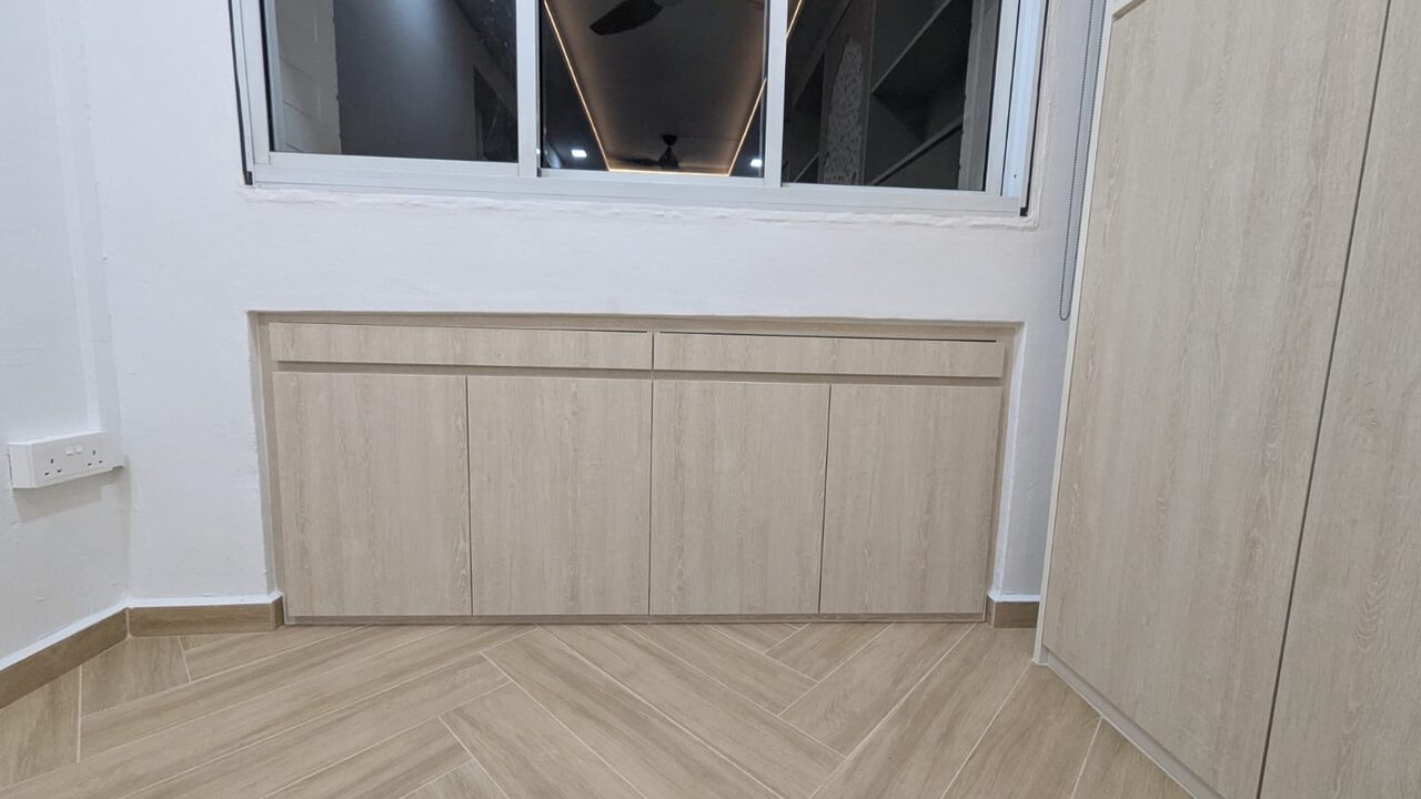 Low light-oak window-base cabinet with slim drawers on a herringbone floor