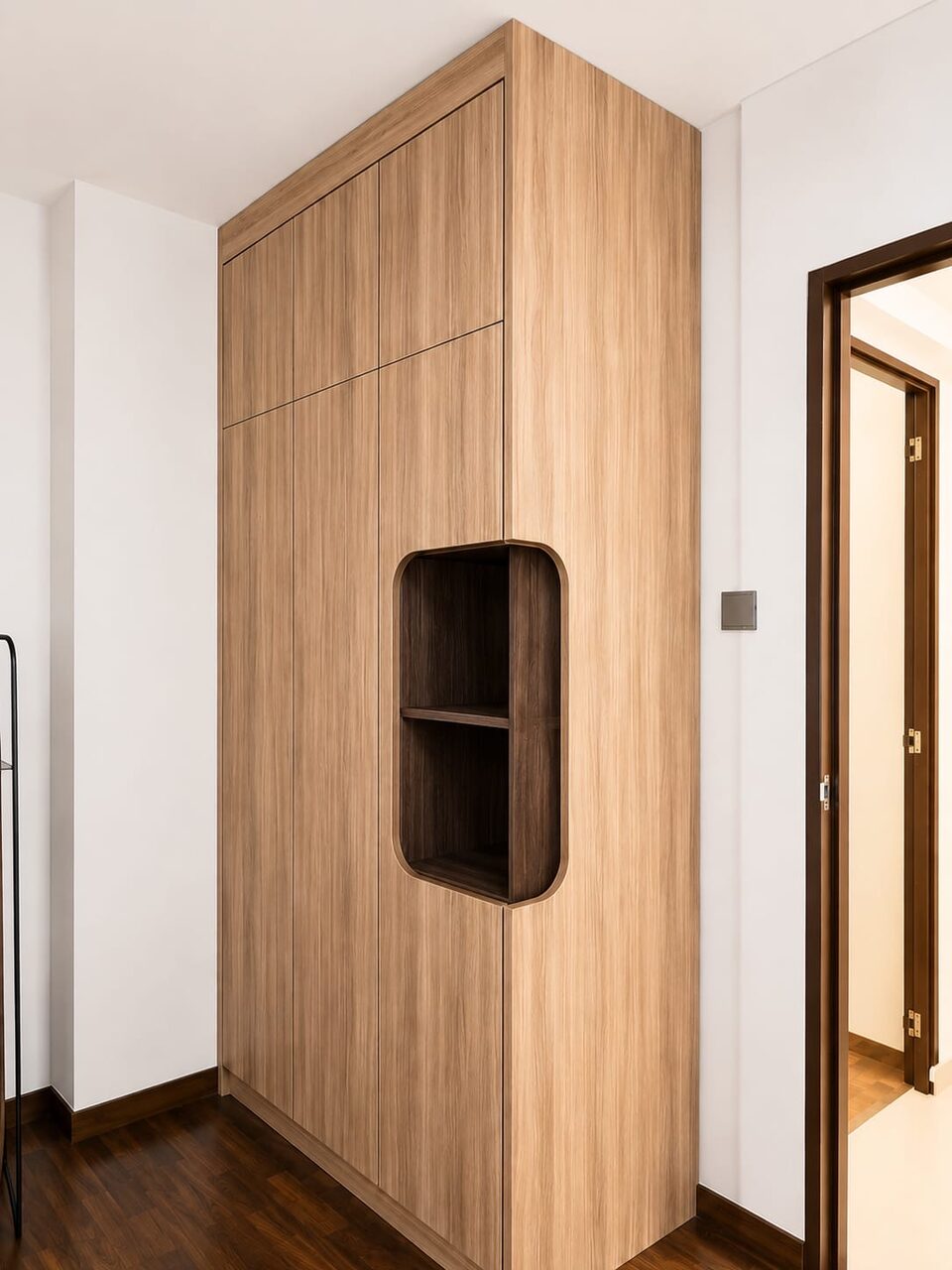Full-height light-oak wardrobe with a rounded walnut display niche